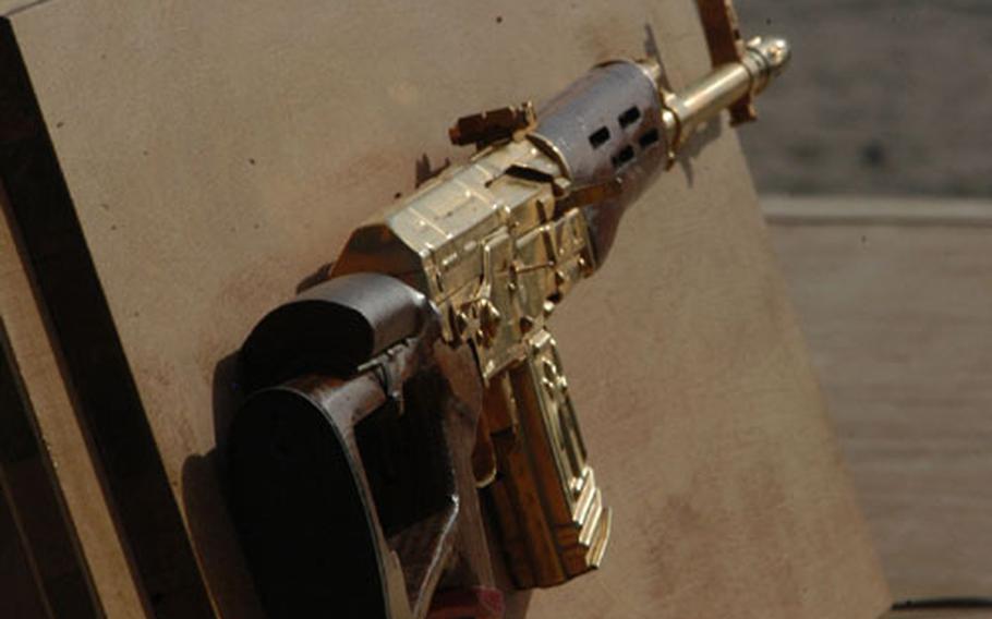 Marine Lt. Gen. John Conway, commander of the First Marine Expeditionary Force, presented one of Uday Hussein&#39;s gold-plated rifles to Seabee commander Rear Adm. Charles Kubic, to thank him for the Seabees&#39; work.