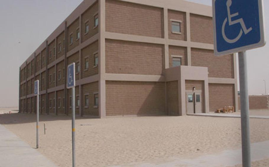 This new building at Camp Arifjan, 30 miles south of Kuwait City, was built to U.S. standards, including offering handicap parking. Arifjan was planned to house U.S. forces, but it wasn&#39;t supposed to be ready until 2005. The war in Iraq hastened the plan.