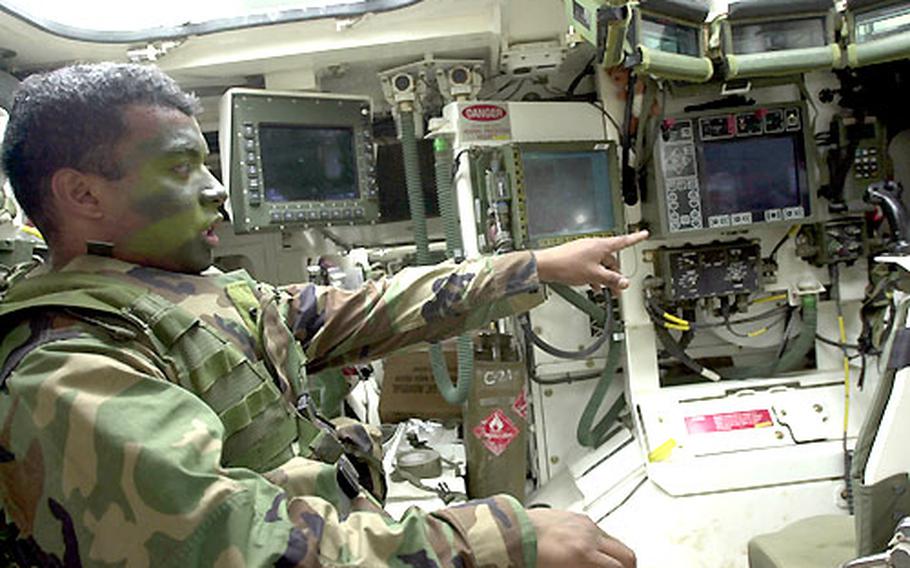 Pfc. Ringo Siangeldeb inside a Stryker vehicle.