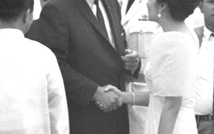 President Johnson is greeted by Philippine first lady Imelda Marcos.