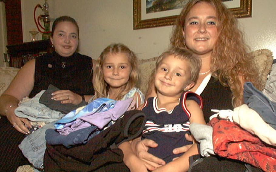 The Family Readiness Group of the 78th Signal Battalion at Camp Zama, Japan, is heading a clothes drive to send civilian clothes to servicemembers serving in Afghanistan and Iraq on a four-day rest and relaxation tour to Camp As Sayliyah, Qatar. FRG leaders Jennifer Moreno (left) and Dominique Unrein, and her children, Cassandra and Brandon, have already gathered several boxes of clothes towards the effort.
