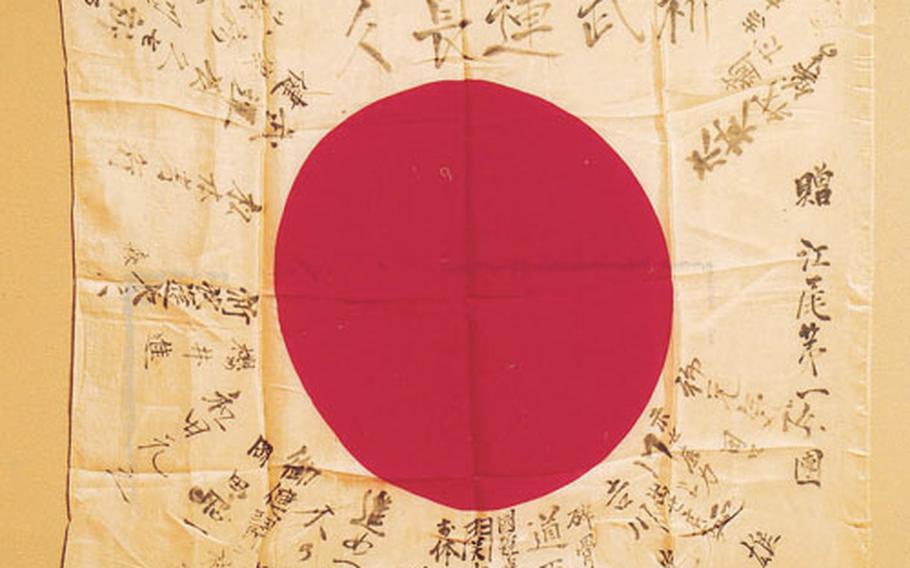 A Japanese battle flag taken as a World War II memento by Robert Walsh was returned to the people who signed it in Ebi. It says, “We pray that you fight fiercely and have long-lasting luck,” and “Go forward and fight fiercely.”