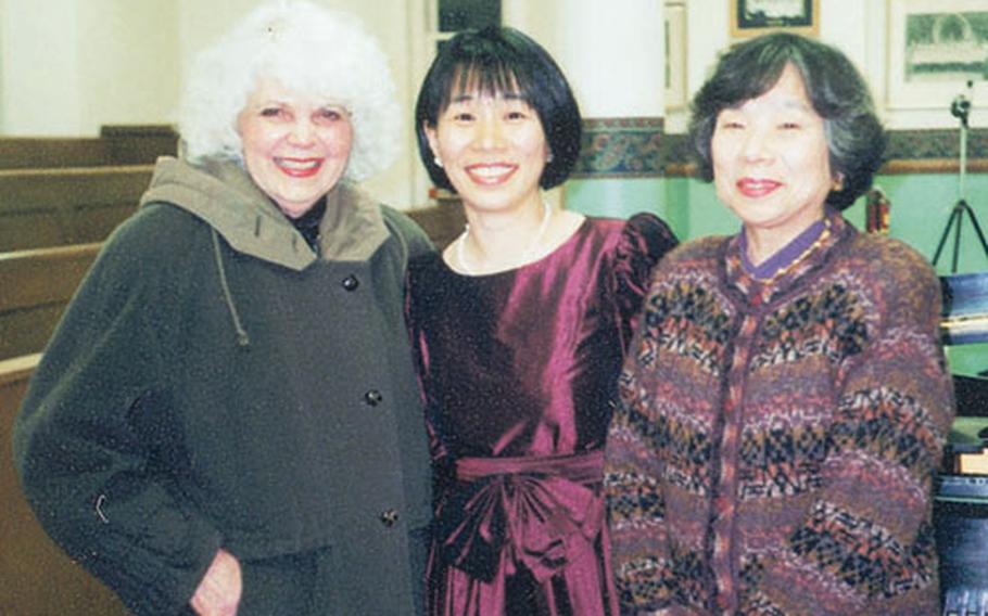 Naoko Caller, in center, helped the Japanese battle flag return to its hometown in Tottori prefecture.