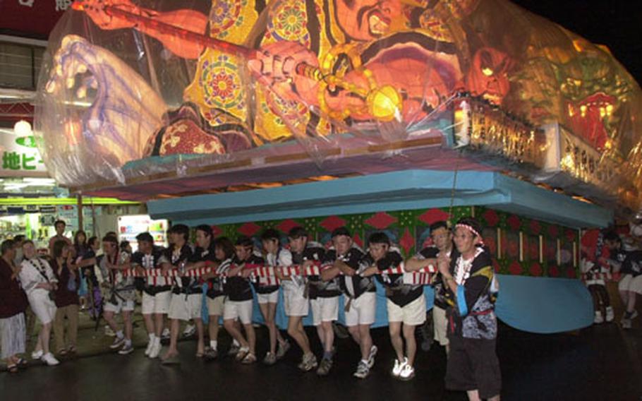 A lighted float which was used during the Nebuta festival in Aomori, Japan, in August is paraded down the street at Yasuniya during the Kunizakai Festival.