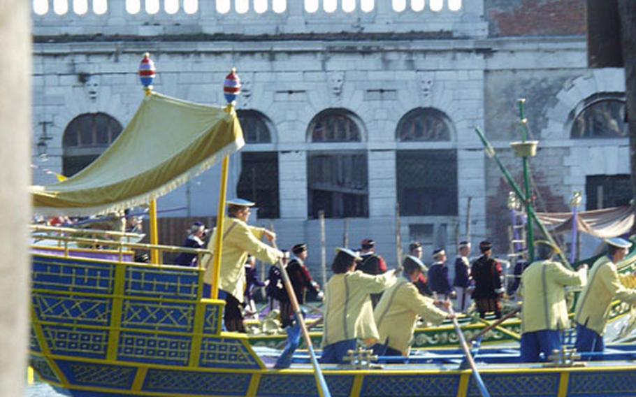 A gondola featuring participants dressed in period costumes makes its way up the Grand Canal toward the Santa Lucia train station on Sunday during the Regata Storica in Venice, Italy. The annual event brings tens of thousands of participants and tourists into the Italian city each year.
