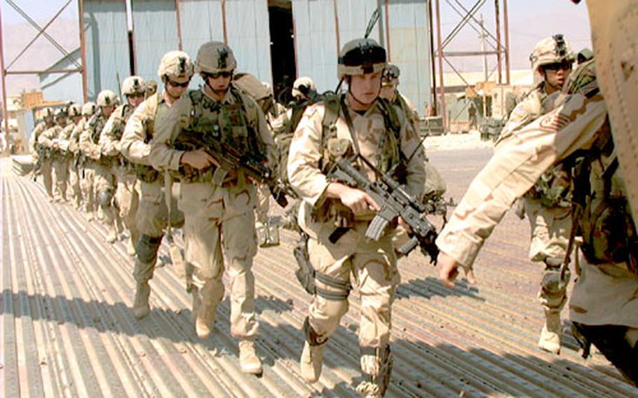 Quick Reactionary Force soldiers load onto a Chinook at the Bagram Air Base flight line Wednesday. The soldiers, from 10th Mountain Division’s Company A, 2nd Battalion, 87th Infantry Regiment, were put on alert and had to be ready to board the Chinook in 15 minutes. The alert turned out to be an exercise.