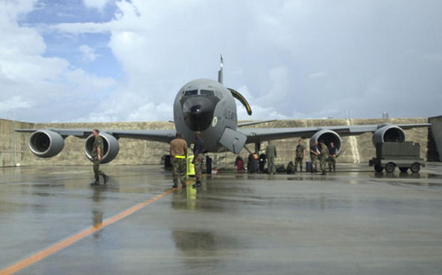 With dark skies looming, Air Force crew members prepare a KC-135 from the 909th Air Refueling Squadron from Kadena Air Base for departure Tuesday in preparation for Typhoon Maemi.