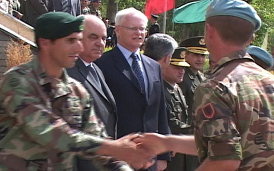 An Albanian commando, right, and fellow commandos, receive congratulations Thursday after completing their first phase of training with U.S. Special Forces. From left, offering their congratulations, are: U.S. Army Capt. Chris Robishaw, Special Forces team leader of the 1st Battalion, 10th Special Forces Group; Albanian President Alfred Moisiu; and U.S. Ambassador to Albania James Jeffrey.