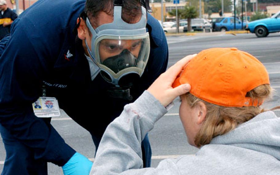 A member of Naval Air Station Sigonella's Naval Hospital questions a volunteer posing as a victim of a simulated terrorist incident Wednesday at Sigonella.