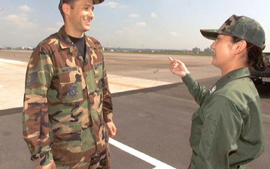 Tech. Sgt. Shane Whitford, chief of airfield management operations at Yokota Air Base, and Hiromi Ikumi, a staff sergeant with the Japan Air Self-Defense Force, worked together in base operations as part of 5th Air Force’s Bilateral Exchange program with JASDF.