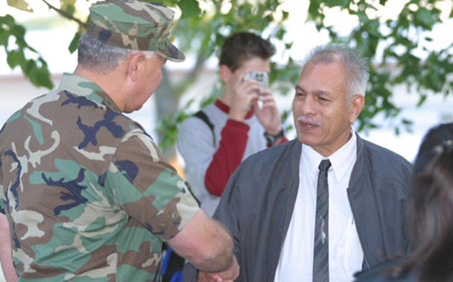 Air Force Gen. Charles Wald, left, U.S. European Command deputy commander, talks with Goyo Chavez Mata, a former prisoner of war from the Korean War, during a ceremony Friday to mark POW/MIA Remembrance Day.