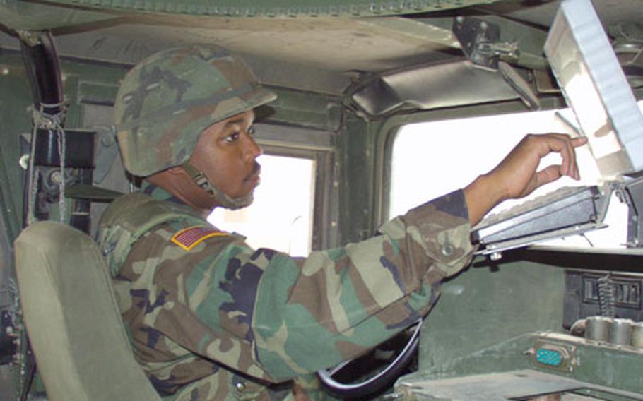 Spc. David McKay, military policeman with the 1137th Military Police Company out of Missouri, uses a BDI inside his Humvee, which is like a global positioning system, just before a patrol outside of Camp Bondsteel, Kosovo, on Friday.