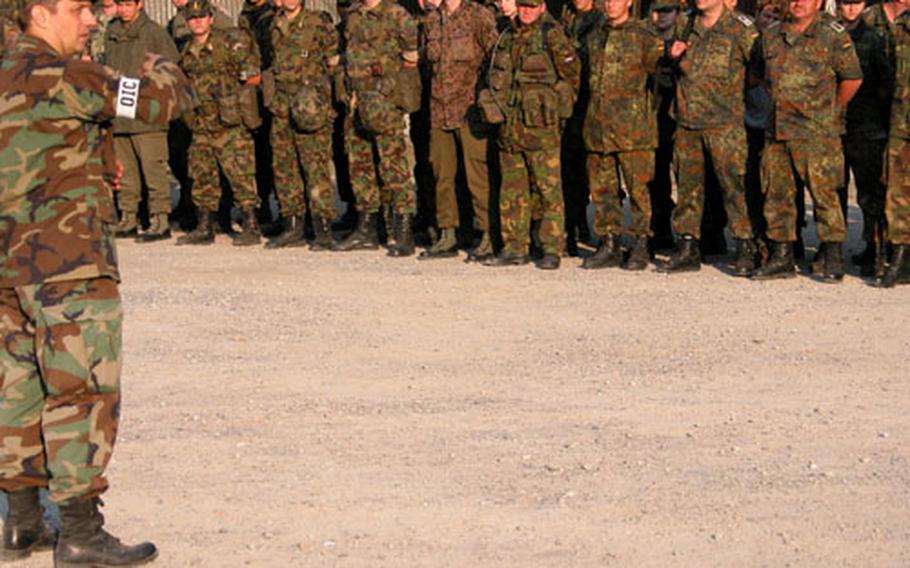 Capt. Helmut Riepl of the 401st Military Intelligence Company, Bad Aibling, Germany, explains the rules of the International Military Skills Competition to soldiers from 10 nations before the start of action Sept. 21 in Brannenberg, Germany.