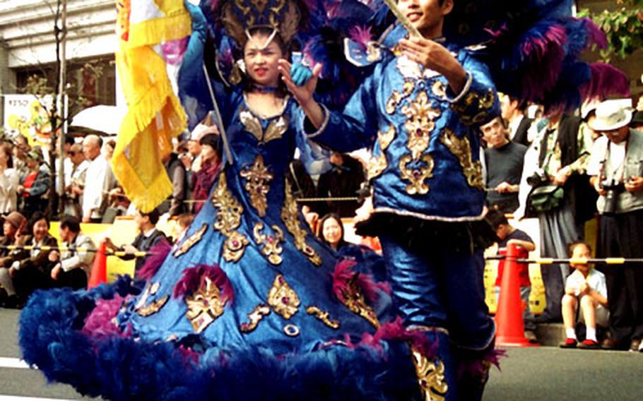 A Liberdade royal couple performs Sunday during the Happy Town Shibasaki Samba Festival in Tachikawa, Japan.