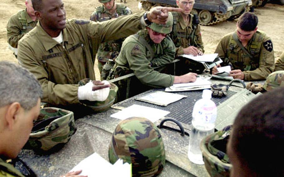 Capt. Dexter Holley, commander of Company B, 2/72 Armor, gives an “op order” brief the day before a simulated battle in the Strike ARTEP exercise Sunday in the hills of South Korea.