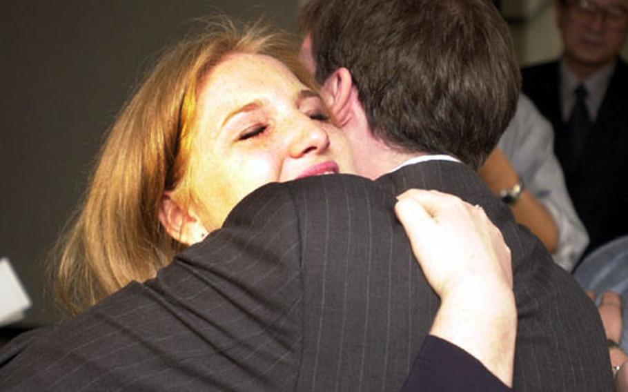 A tearful Kenzi Snider hugs her attorney, Brendan Carr, after a South Korean judge acquitted her of murder charges Tuesday in Seoul.