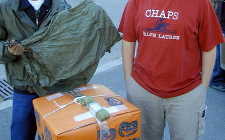Marcelo "Casper" Harper, left, and Brandan Reed, Patch High School juniors, wait for their turn in the 1st annual Great American Pumpkin Patch Drop. The pumpkin drop container made by the duo was one of only three of 15 that did not damage their pumpkins after being dropped from a 70-foot tall fire engine ladder.