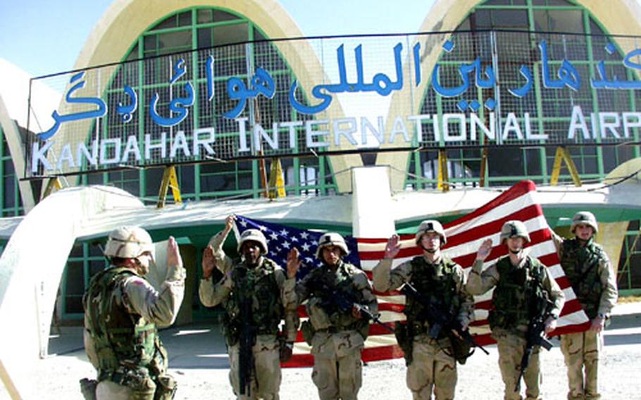 The members of the 101st Airborne Division’s 3rd Brigade, known as the Rakkasans, have been keeping a brutal pace, with deployments in Kosovo, Afghanistan and Iraq. But that hasn’t stopped brigade troops from re-enlisting: In February 2002, from left, Staff Sgt. Stanley L. Richardson, Spc. Armando L. Acevedo Jr., Spc. Adrian M. Hollar and Staff Sgt. Scott M. Weaver are sworn in at Kandahar airfield in Afghanistan.