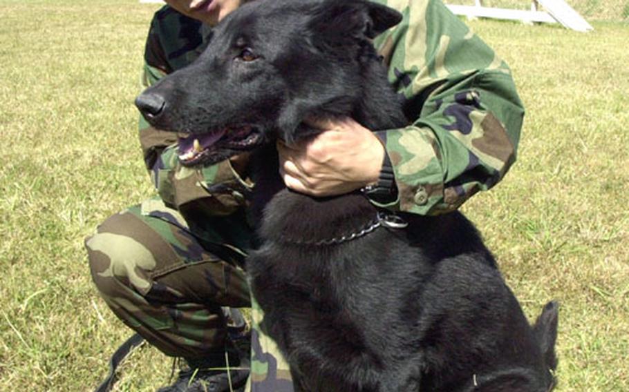 Sentaro Koda, a military dog handler and a 16-year employee of the Sasebo Naval Base Security Detachment's K-9 unit, adopted his retiring longtime partner Friday afternoon. Koda and Nero, an 11-year-old German shepherd, trained and worked together for several years.