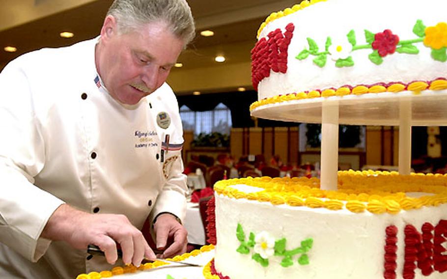 Corporate chef Wolfgang Geckeler smooths out the icing on the ceremonial birthday cake before a Marine Corps Ball at the Butler Officer’s Club on Monday. The club is hosting 19 of the 46 birthday balls on Okinawa.