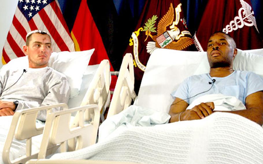 Sgts. Raymond Littlefield, left, and Christopher Nelson talk to the media on Wednesday at Landstuhl Regional Medical Center in Germany. Both were injured when a CH-47 Chinook helicopter was shot down over Iraq on Sunday. Fifteen soldiers died in one of the deadliest attacks against U.S. forces since the war began.