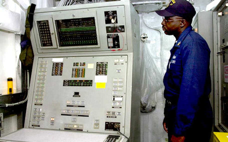 Petty Officer 1st Class Julian Maxwell, leading petty officer for the combat and guns division aboard the guided-missile frigate USS Nicholas, looks at the controls that launch the SM-1. The Navy is removing guided-missile launchers from all frigates by 2010.