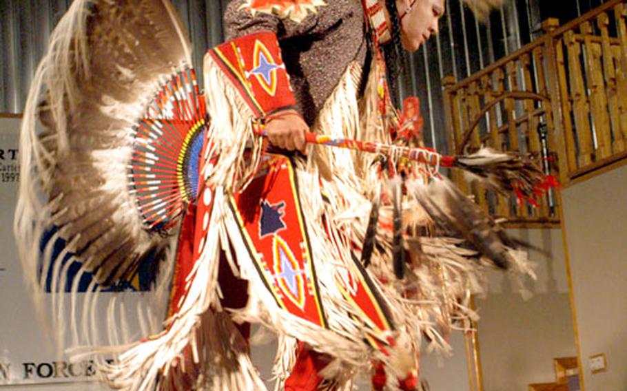 Clad in colorful regalia, Patrick Moore, an American Indian from Oklahoma, dances during the show at Camp McGovern, Bosnia and Herzegovina Wednesday evening.