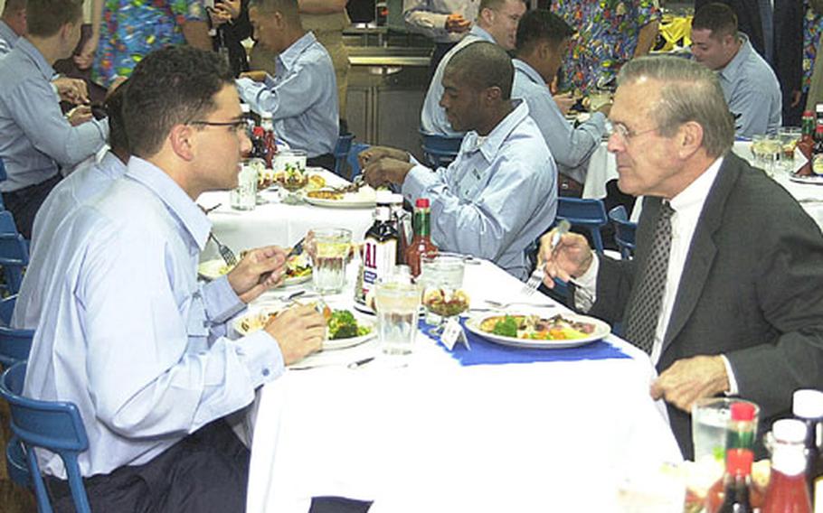 (left to right) Petty Officer 3rd Class Brandon Fraiser said he and Defense Secretary Donald Rumsfeld discussed Cold War politics during lunch onboard USS Blue Ridge Saturday.