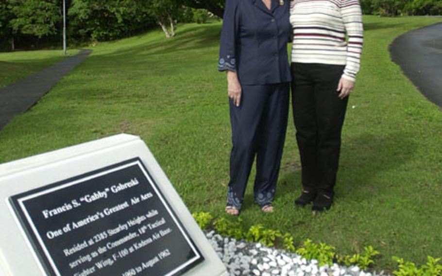 Gayle Stevenson Goodman, left, and Lori Dallas stand by the monument honoring Col. Francis S. "Gabby" Gabreski on Kadena Air Base. Gabreski was the eighth Jet Ace in history.