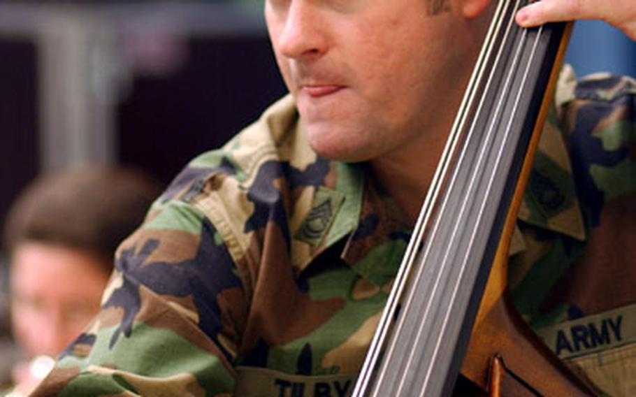 Sgt. 1st Class Larry Tilby, of the U.S. Army Europe Band, focuses while playing his bass during a rehearsal.