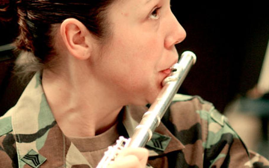 Sgt. Jennifer Meris, of the U.S. Army Europe Band, plays the flute during a rehearsal