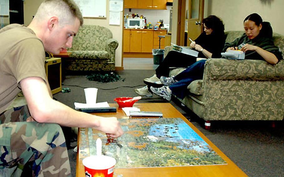 Spc. Mark Graber relaxes Tuesday at the Camp Red Cloud coffee house, where soldiers can get a break from barracks life.