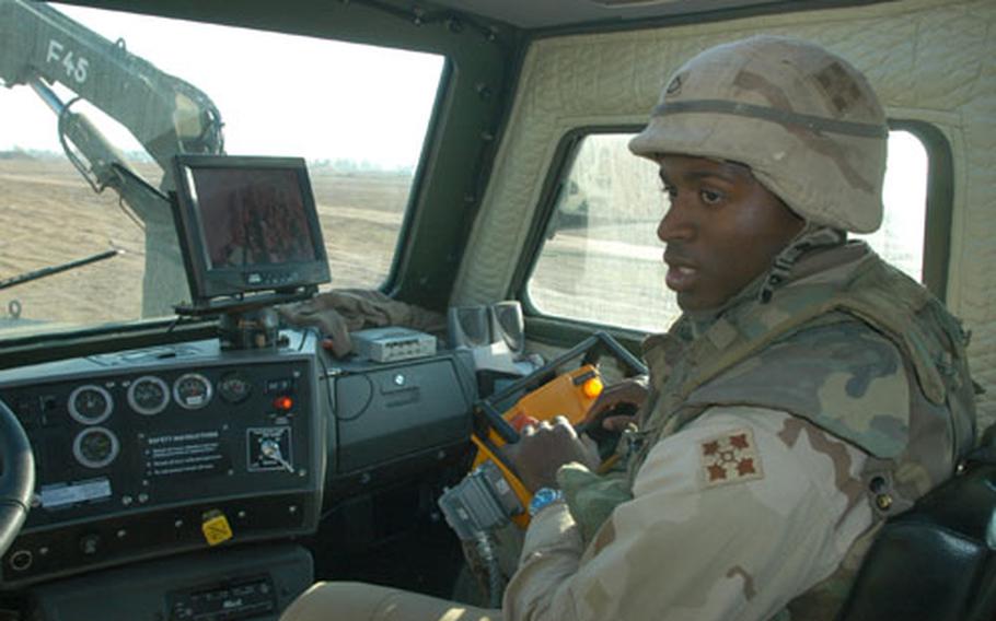 Pfc. William Stribling, 19, of Brooklyn, N.Y., operates the remote control arm on a Buffalo, the Army's latest equipment to counter the threat of roadside bombs in Iraq.