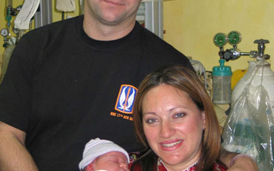 Chief Warrant Officer Jerome Goldick and his wife, Judy, hold Juliana Mae, who was born at the 121st General Hospital at Yongsan Garrison just after 3:20 a.m. on New Year's Day.