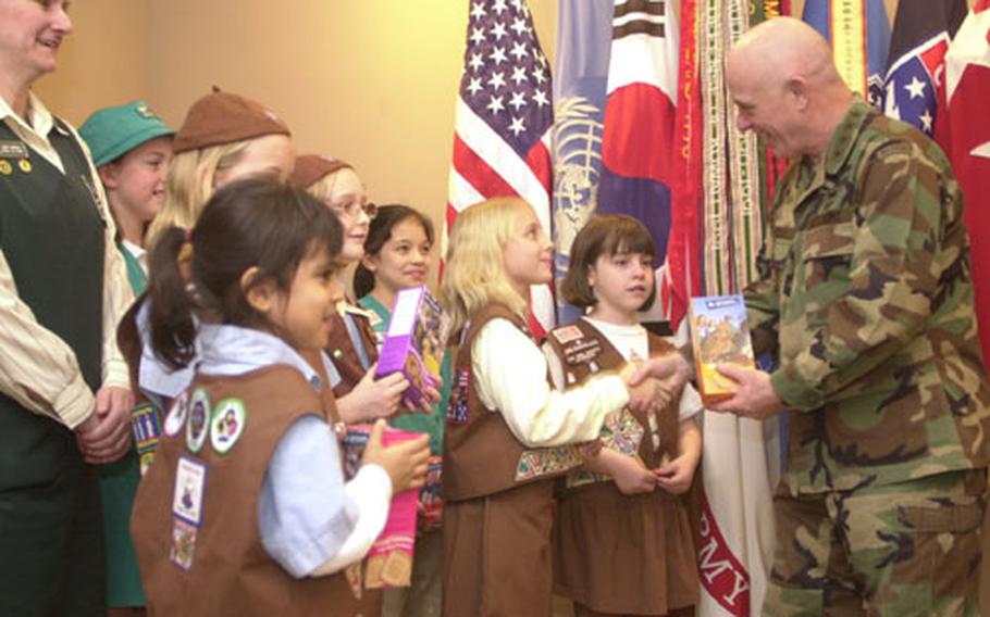 U.S. Forces Korea commander Gen. Leon LaPorte buys the first boxes of Girl Scout cookies sold this year in South Korea. Girl Scouts throughout the peninsula will officially kick off the sales Friday afternoon.
