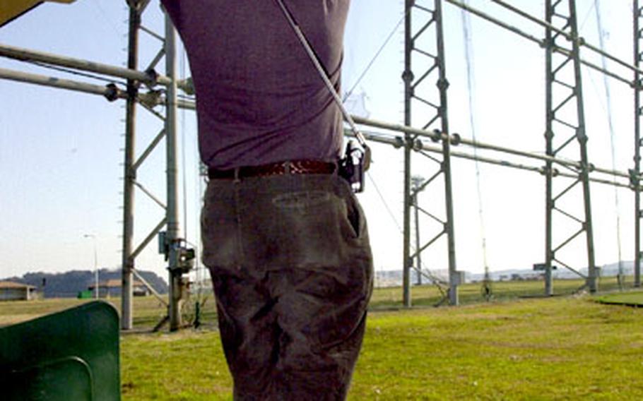 Dennis Foye, design superintendent for Ship Repair Facility Yokosuka, works on his golf swing last week at the driving range at Yokosuka Naval Base, Japan.