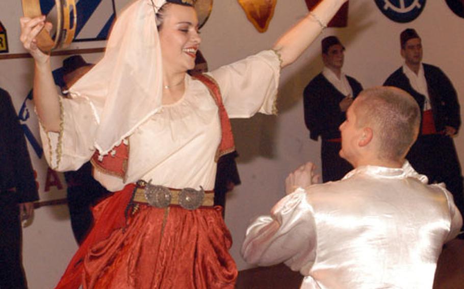 Bosnian folklore dancers perform for American troops at Eagle Base, Bosnia and Herzegovina, on Friday evening.