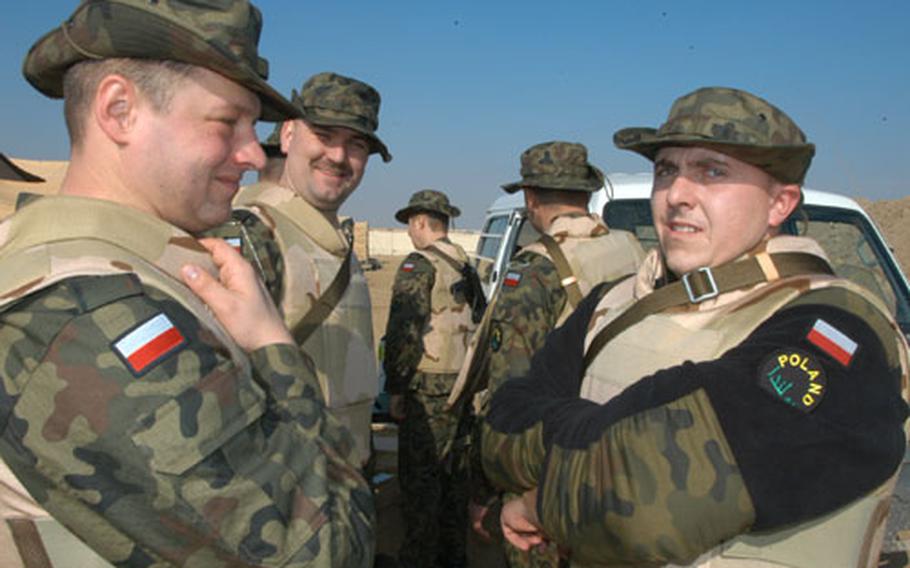Polish soldiers, sporting U.S.-issued bullet proof vests, gear up for operations in Iraq last week at Camp Virginia, Kuwait.