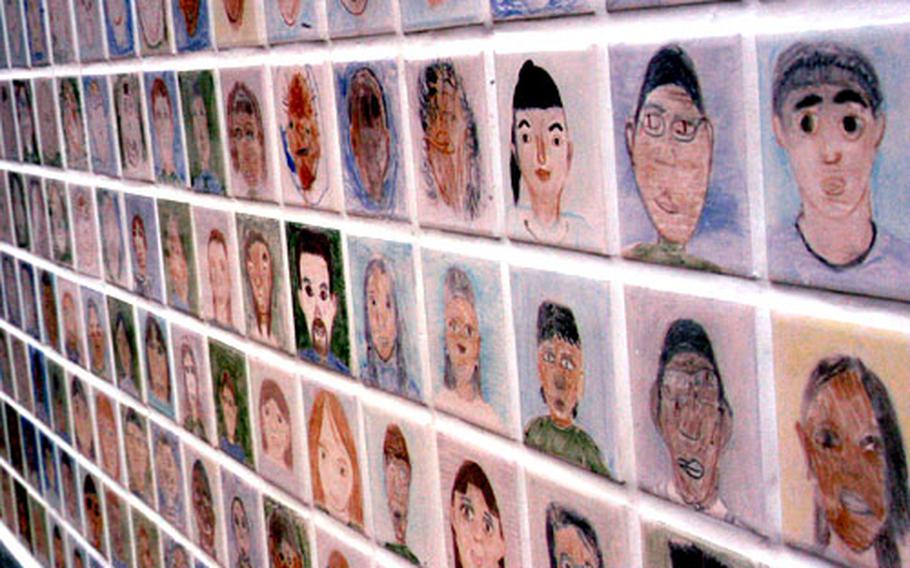 A wall outside the new John O. Arnn Elementary School at the Army's Sagamihara housing area in Tokyo holds the likenesses of more than 500 teachers and students.