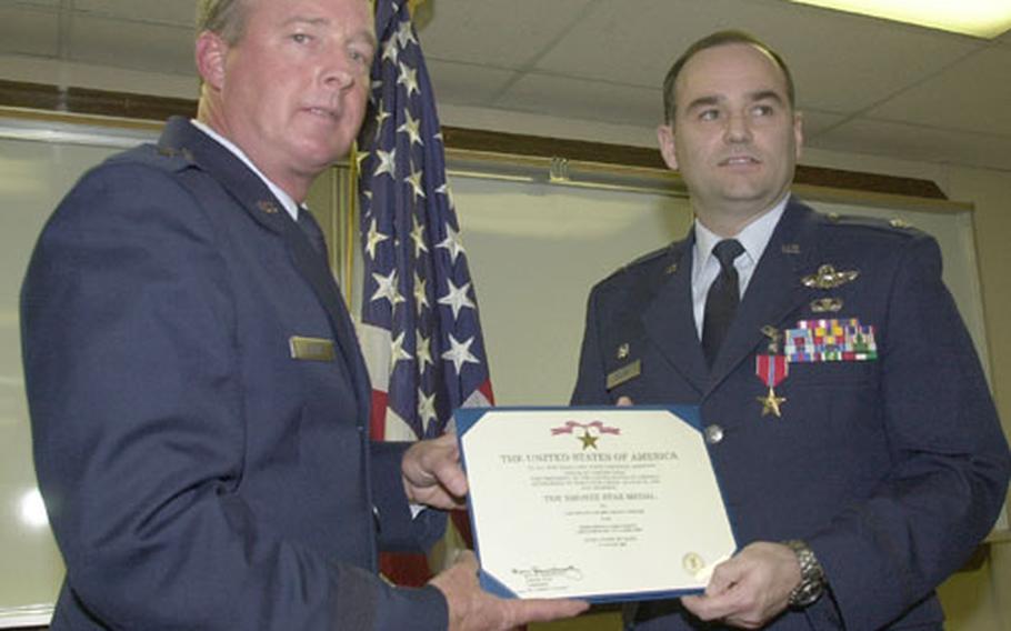 Brig. Gen. Dana Atkins, left, 35th Fighter Wing and Misawa Air Base commander, pinned the Bronze Star Medal on Lt. Col. Kevin Fowler and presented him a certificate of his award at a medals ceremony last week at Misawa. Fowler, a fighter pilot, received the award for service during Operation Iraqi Freedom.