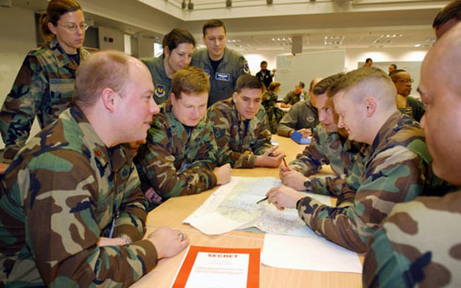 U.S. airmen plan for combat air operations Wednesday during the first phase of Austere Challenge 2004. The three-phase exercise is designed to certify U.S. Air Forces in Europe's ability to perform its mission as a warfighting headquarters.