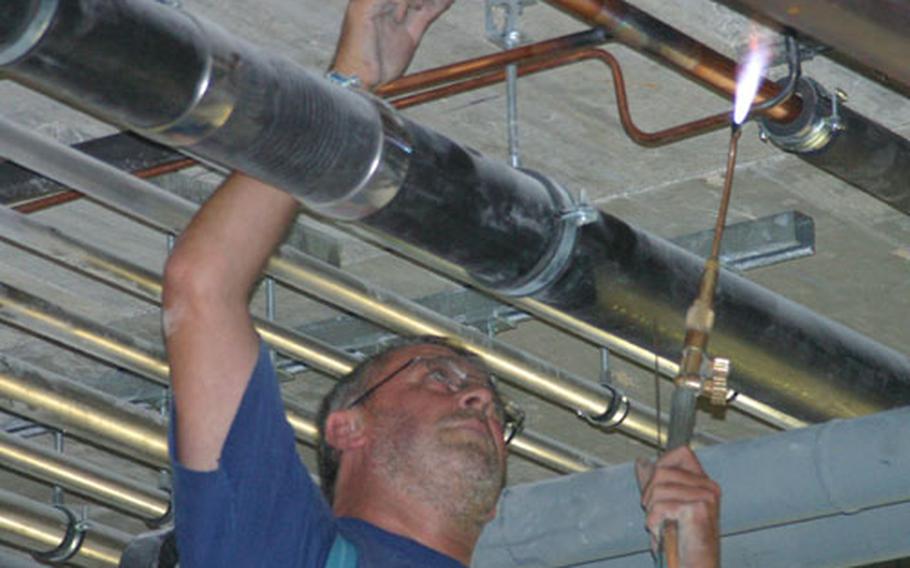 A worker solders pipes at the Edelweiss Lodge and Resort being built in Garmisch, Germany.