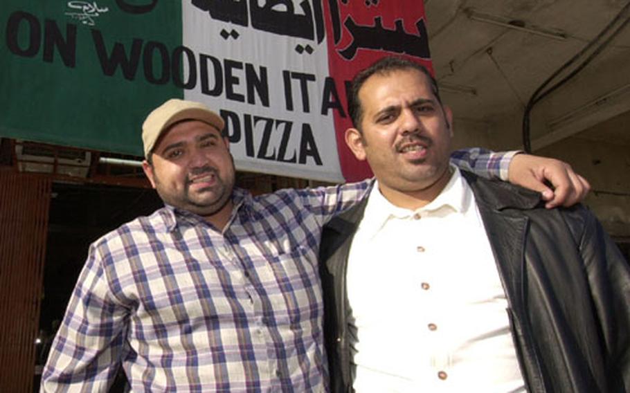 Wa-Il Al-Bayati, left, and Waleed Al-Bayati stand in front of their restaurant after their new windows were installed Monday.