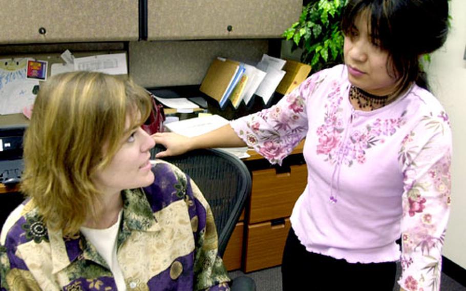 Angel Person, left, director of the Navy-Marine Corps Relief Society office at Sasebo Naval Base, Japan, and her volunteer staff, which includes Lyn Pipkin, right, managed 145 separate cases of help for servicemembers with financial needs in 2003, disbursing $67,435 in loans and grants.