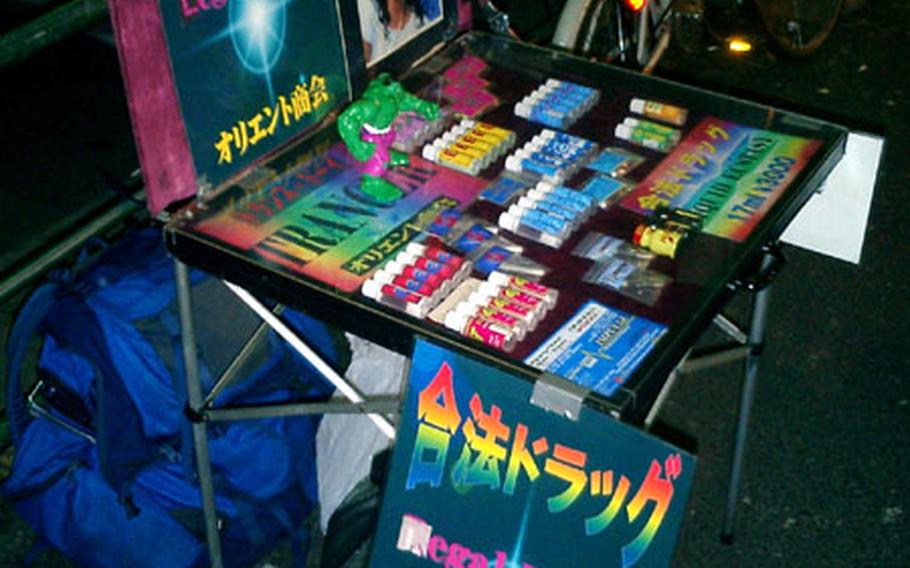"Legal Drugs" in bright neon lettering entices patrons to a table in Tokyo&#39;s Roppongi bar district. Drugs such as "Foxy" and "AMT" may be legal in Japan, but they&#39;re not legal for U.S. servicemembers.