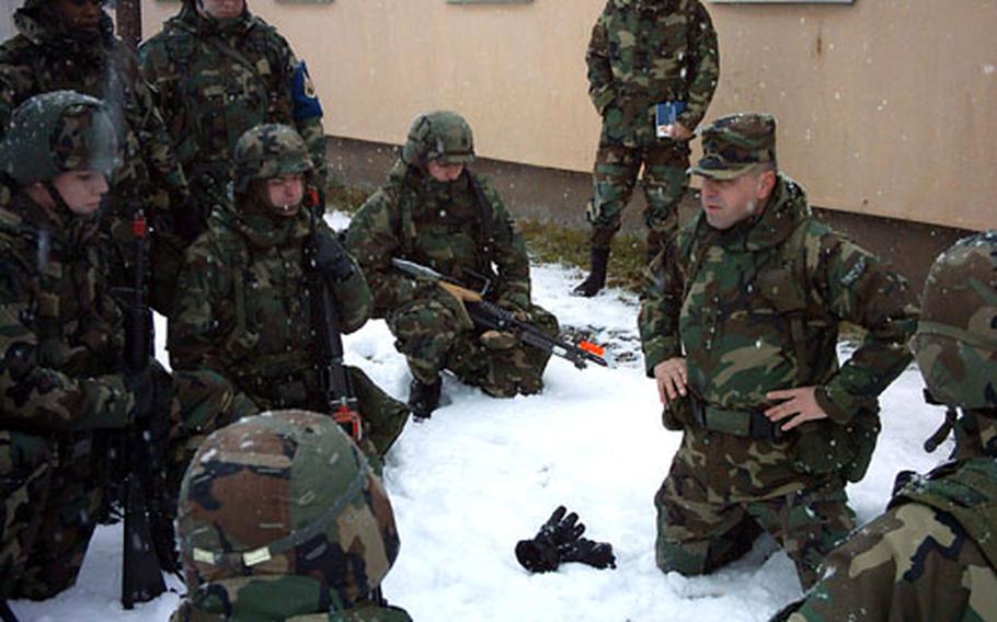 Staff Sgt. Anthony Makar demonstrates squad movement techniques to Primary Leadership Development Course students Wednesday at the Grafenwöhr Training Area in Germany.
