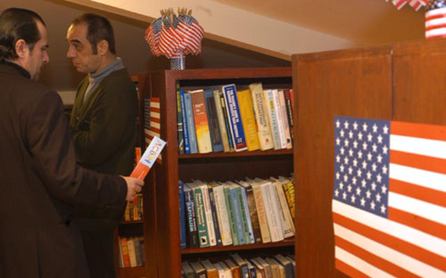 Visitors of the newly opened American Corner at the library in Tuzla, Bosnia and Herzegovina, check out the books.