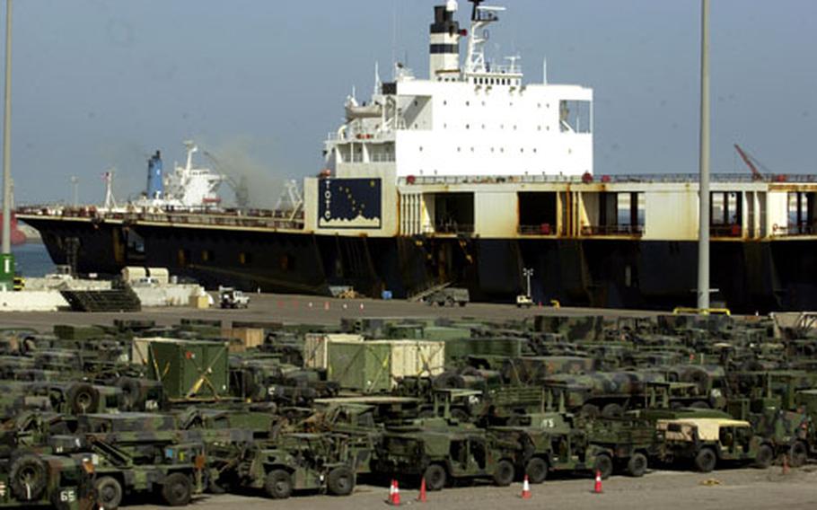 Hundreds of military vehicles are lined up at Shu'Aibah Port, Kuwait, after being unloaded from cargo ships.
