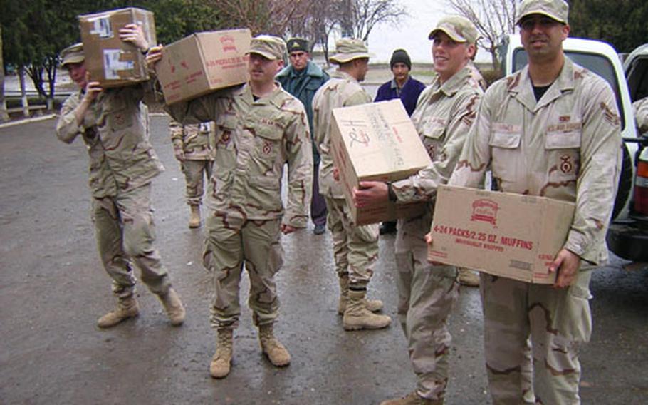 U.S. Air Force members unload donated supplies at a school in Khanabad, Uzbekistan. Students at Aviano High School in Italy solicited donations of school supplies from community members in December. The donations were sent to the former Soviet republic in care of the members of the 31st Security Forces Squadron deployed there.
