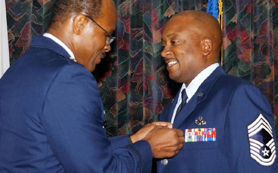 Maj. Willie Holt Jr., 18th Component Maintenance Squadron commander, left, pins a Bronze Star on Chief Master Sgt. Terrence Frost, superintendent of the 18th CMS.